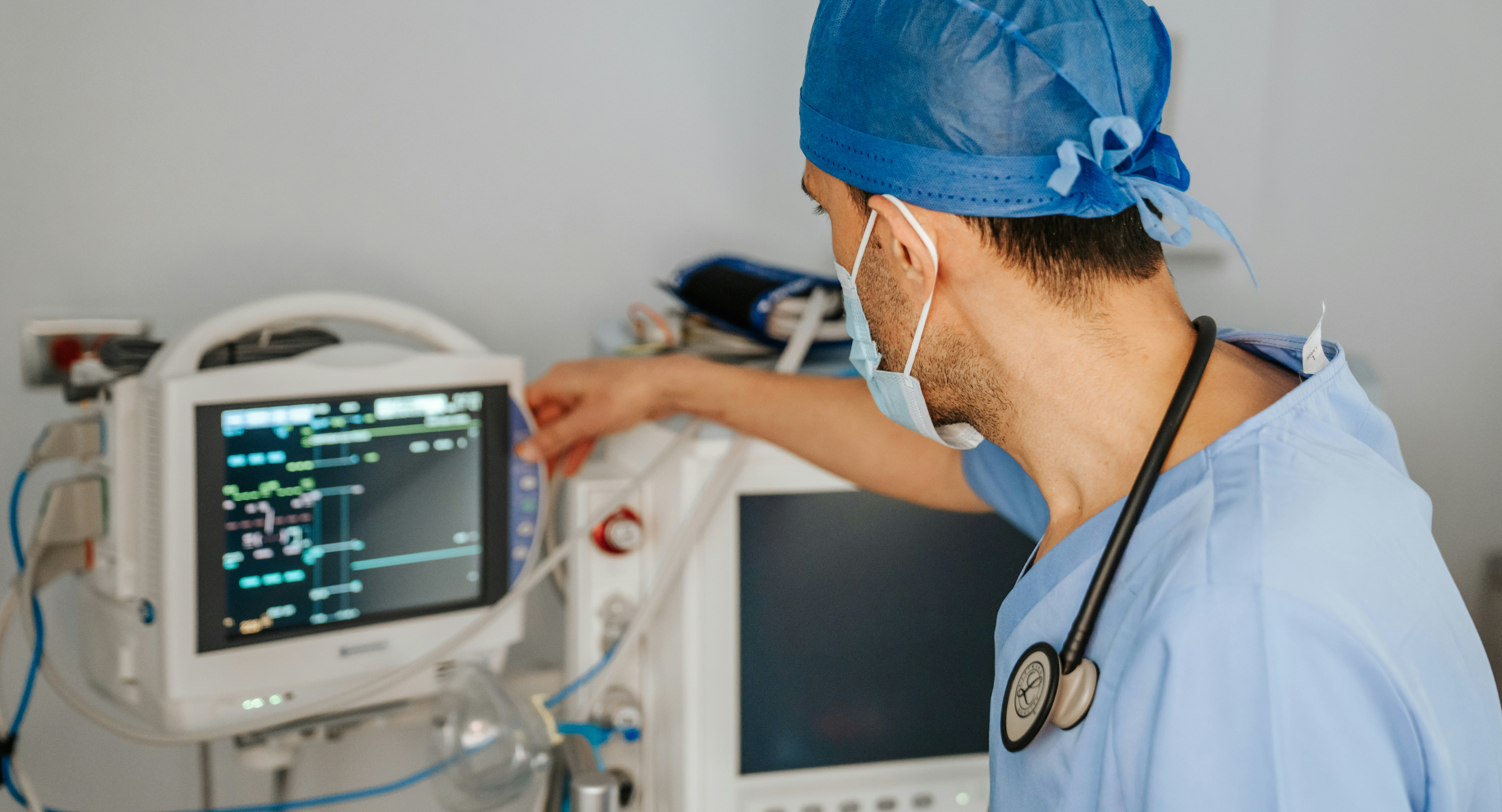 A medical professional examines a patient's vitals on a machine.