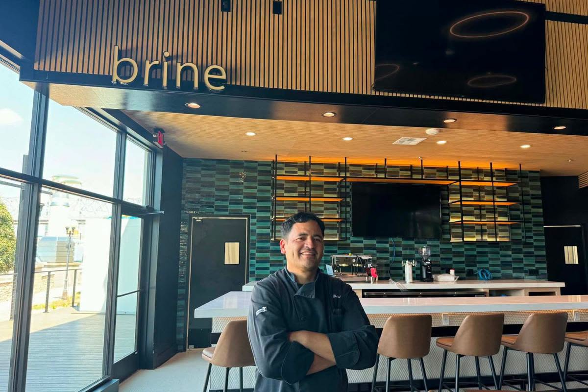 Chef Gabriel Balderas smiling within the modern interior of The Brine.