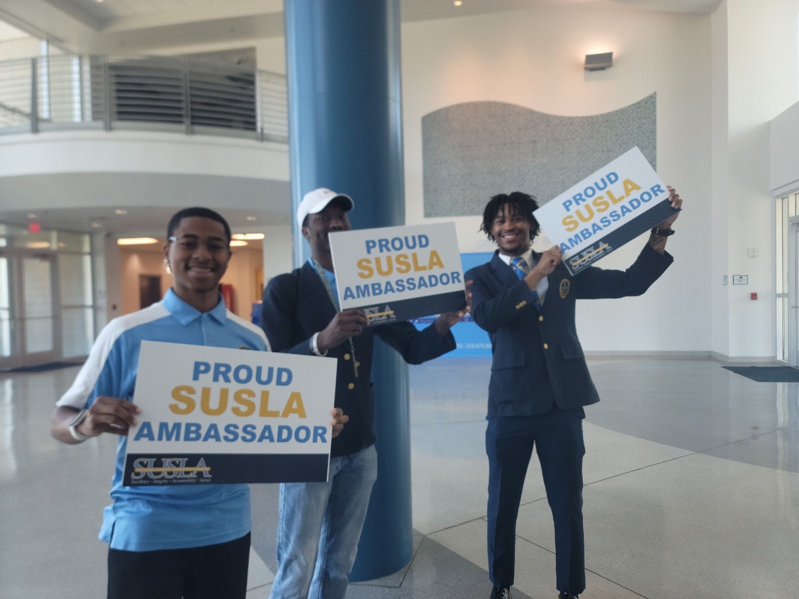 Student with SUSLA Ambassador sign