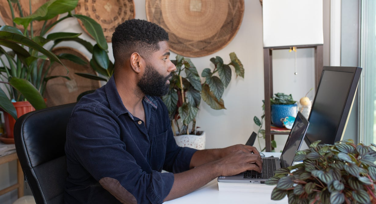 A man works on a computer in an office.